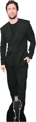 A full-body cardboard cutout of actor Aaron Taylor-Johnson in a black suit.