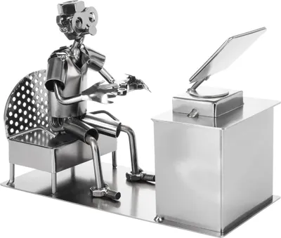 A metal figurine of a gamer sitting at a desk with a computer.