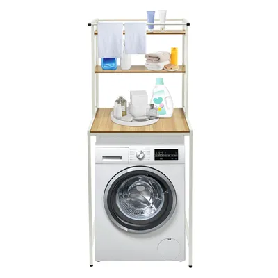 A washing machine with a three-tiered shelf unit above it, containing various bathroom and laundry items.