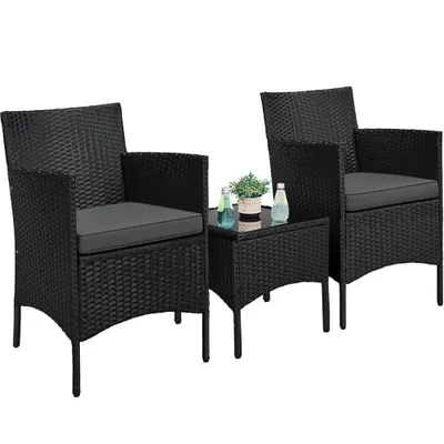 A black rattan furniture set with two chairs and a small table on a white background.