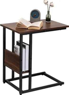 A dark wood-effect side table with a black metal frame, featuring a shelf for books and a small magazine rack.