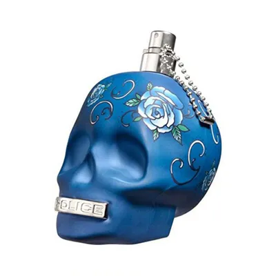 A blue skull-shaped perfume bottle with floral designs.