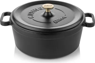 A black cast iron pot with a gold knob on its lid.