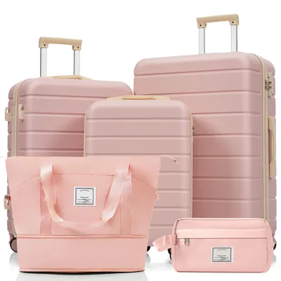 A set of pink luggage and travel bags arranged on a white background.