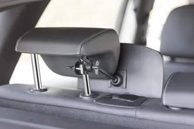 Close-up of a car's headrest with a device attached.