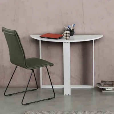 A modern desk and chair setup in a room with a textured wall.