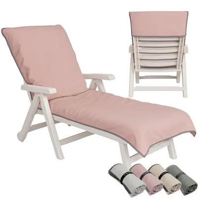 A pink chaise lounge cushion on a white wooden chaise lounge, with a view of the back of the chaise lounge and a set of rolled-up towels in different colors at the bottom.