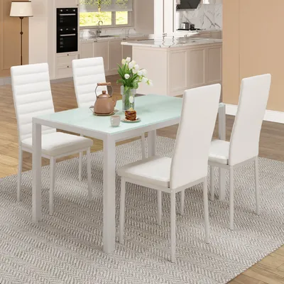A dining set with a glass-top table and four white chairs in a modern kitchen.