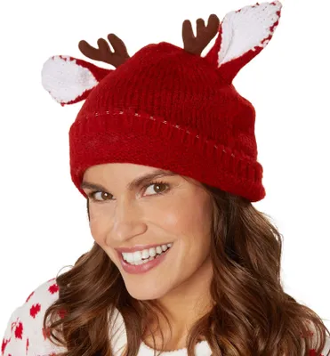 A woman wearing a red reindeer hat and sweater.