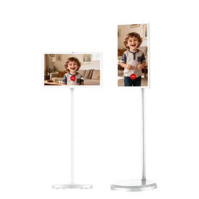 Two smart displays on stands, each showing a video call with a young boy.