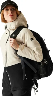 A woman wearing a jacket and backpack, posing for a product shot.