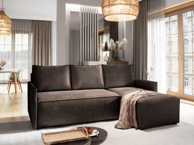 A modern living room with a large sectional sofa, a coffee table, and large windows.