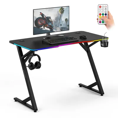 Immagine prodotto di Sense7 VOLT RGB, scrivania da gaming, 120x60 cm, nera, con illuminazione LED, scrivania per computer, design effetto carbonio, scrivania da gaming, con portabicchieri