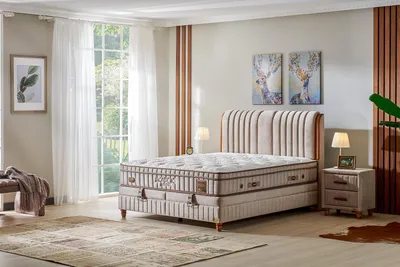 A bedroom scene featuring a bed, nightstand, and rug.