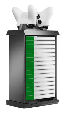 A black and white game controller charging tower with green accents, holding two white game controllers on top.