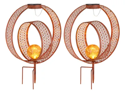 Two decorative solar garden lights with a rustic, rusty appearance and a textured glass ball in the center.
