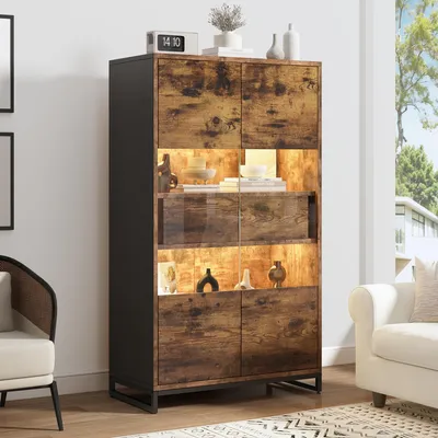 A tall cabinet with LED lighting is displayed in a living room setting, next to a sofa and chair.