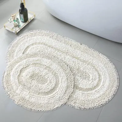 Zdjęcie produktu dla Zestaw dwóch owalnych mat do łazienki Unyqoos® wykonanych z bawełny, kolor kremowy – miękkie, chłonne i nadające się do prania w pralce, idealne do łazienki i toalety