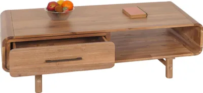 A wooden coffee table with a drawer and a shelf, decorated with a bowl of fruit and a book.