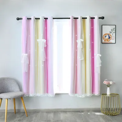 A room with curtains, a chair, and a small table with flowers.