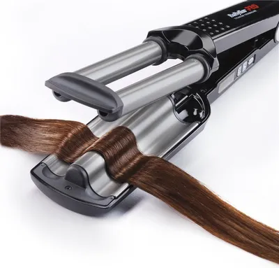 A close-up shot of a hair crimper with brown hair being styled.