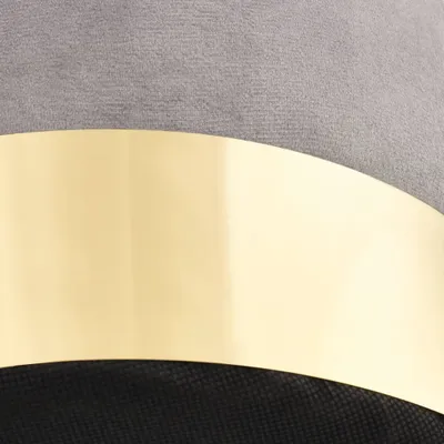 A close-up shot of a section of a chair, showing the textured gray fabric, a curved gold band, and black material underneath.