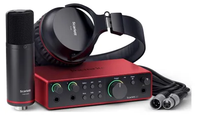 A studio recording kit including a microphone, headphones, and an audio interface.