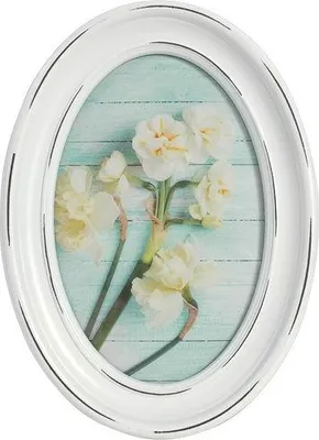 An oval picture frame with a floral image inside.