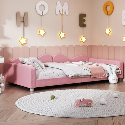 A child's bedroom with a pink bed, decorative letters on the wall, and a round rug on the floor.