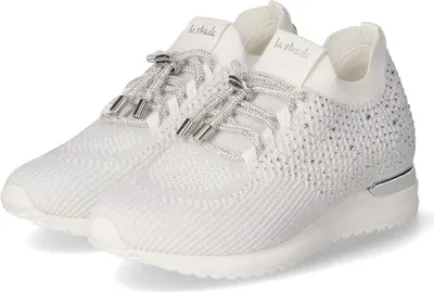 A pair of white sneakers with silver accents and embellishments.
