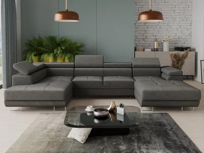 A modern living room with a large sectional sofa, coffee table, plants, and a credenza.