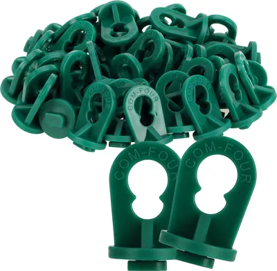 A pile of green plastic greenhouse clips.