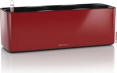 A red planter with a black interior and a water level indicator.