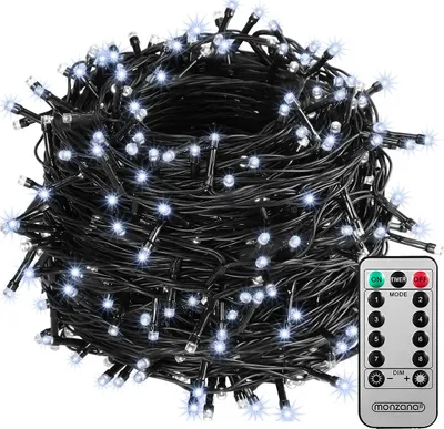 A coiled string of white LED lights with a black wire, shown with a remote control.