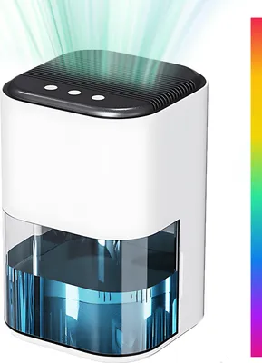 A white and clear dehumidifier with blue water in the reservoir, emitting green light beams from the top.