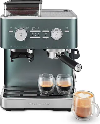 A KitchenAid espresso machine with integrated coffee grinder, shown with two espresso cups and a latte cup.