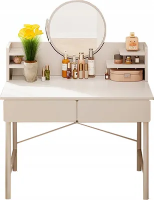 A white vanity table with a mirror, drawers, and various cosmetic products arranged on top.