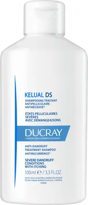 A white bottle of shampoo with blue and white labeling.