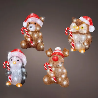 Four illuminated Christmas figures: a bear, an owl, a penguin, and a reindeer, each holding a candy cane and wearing a Santa hat.