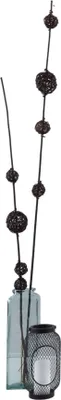 Decorative sticks with balls in a vase next to a lantern.