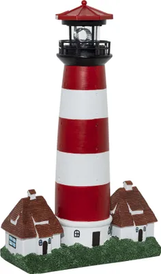 A decorative lighthouse with two small houses at its base, set against a white background.