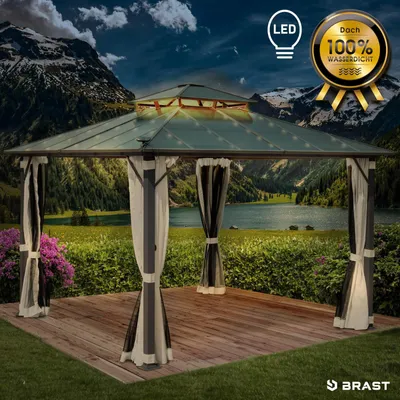A gazebo with LED lights is set up in a scenic outdoor location with mountains and a lake in the background.