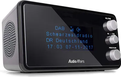 A digital radio alarm clock with a display showing station information and time.