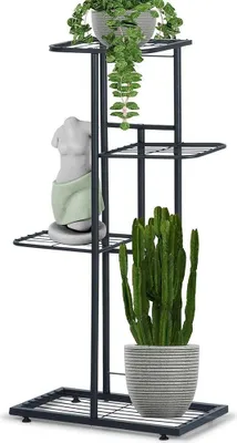 A black metal plant stand with four tiers, holding three potted plants and a decorative bust.