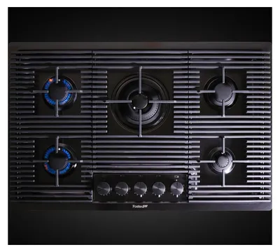 A top-down view of a gas stovetop with five burners, two of which are lit with blue flames.