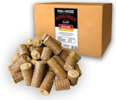 A pile of wood briquettes in front of a cardboard box.