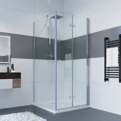 A modern bathroom with a glass shower enclosure, a vanity, and a towel warmer.