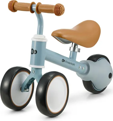 A blue Kinderkraft CUTIE balance bike with brown handlebars and seat, shown on a white background.