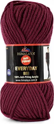 A ball of burgundy yarn with a label wrapped around it.