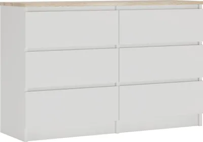 A white dresser with a light brown top.
